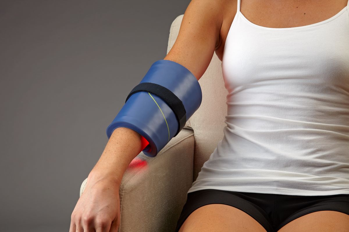Woman torso with the celluma home wrapped around her elbow